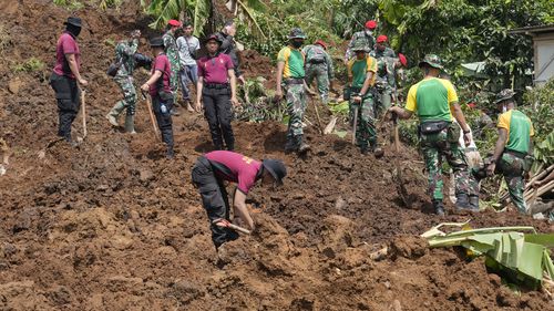 Rescuers search for victims of an earthquake-triggered landslide in Cianjur, West Java, Indonesia, Wednesday, Nov. 23, 2022. 