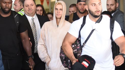 Bieber was flanked by security guards.