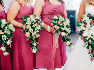 Bridesmaid standing with bride