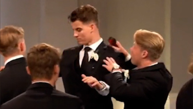 Groomsmen helping groom prepare for first kiss.