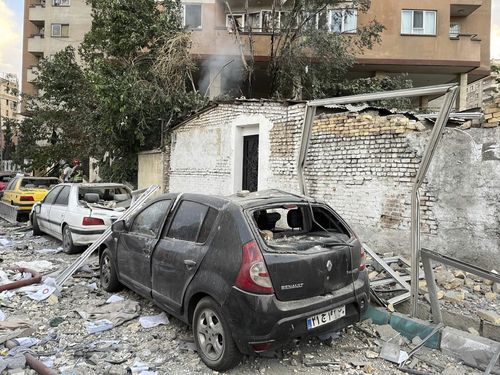 Debris from an flat building is seen connected apical of parked cars aft a onslaught successful Tehran.