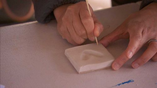 Ceramic heart-shaped tiles are formed by the fingerprints of Connie’s “villagers”. (9NEWS)
