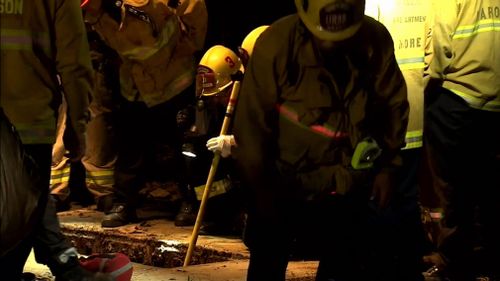 Rescuers had dropped floating cameras into the drainage system in an effort to find the teenager and handed him a mobile phone to call his parents before pulling him to safety. (9NEWS)