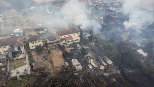 WENNINGTON, GREATER LONDON - JULY 19: In this aerial view, smoke from fires in a residential area being fought by fire services are seen on July 19, 2022 in Wennington, England. A series of grass fires broke out around the British capital amid an intense heatwave. (Photo by Leon Neal/Getty Images)