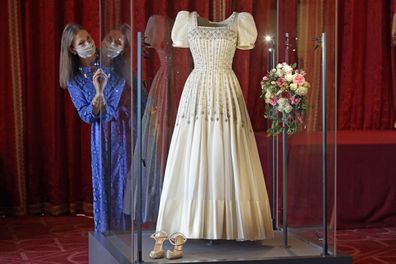 Caroline de Guitaut Deputy Surveyor of The Queen's Works of Art views Princess Beatrice's wedding dress, designed by the renowned British fashion designer Sir Norman Hartnell and loaned to by Queen Elizabeth II, on display at Windsor Castle in Windsor, England, Wednesday, Sept. 23, 2020