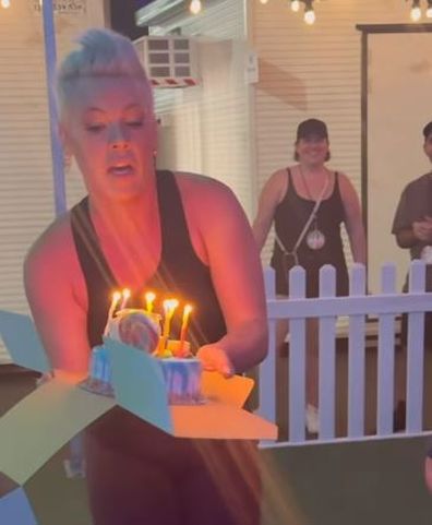 Pink surprising fan with birthday cake