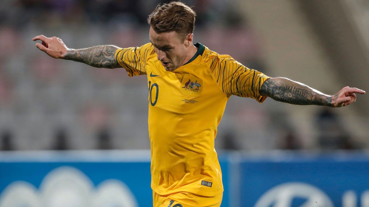 Adam Taggart celebrates scoring for the Socceroos