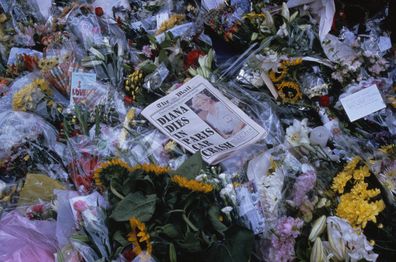 Copy of The Daily Mail newspaper on a sea of flowers at memorial for Princess Diana in front of Buckingham Palace. (Photo by robert wallis/Corbis via Getty Images)