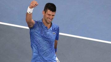 Novak Djokovic raises his fist after winning the Australian Open semi final.