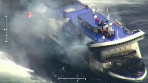 Smoke and flame pour from the damaged ferry. (AAP)