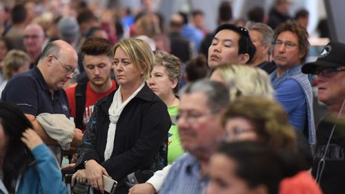 Huge queues are seen at Sydney Airports T2 Domestic Terminal as passengers are subjected to increased security following a number of terror raids over the weekend. (AAP Image/Dean Lewins).