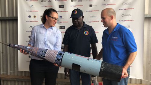 ELA CEO Carley Scott with Djawa Yunupingu (Gumatj Corporation Board member), Blake Nikolic (CEO Black Sky Aerospace). The nosecone design is by Dorothy Yunupingu of Djulpan, despicting the seven sisters.