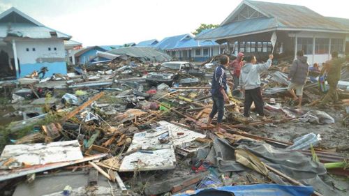 Locals survey the damage.