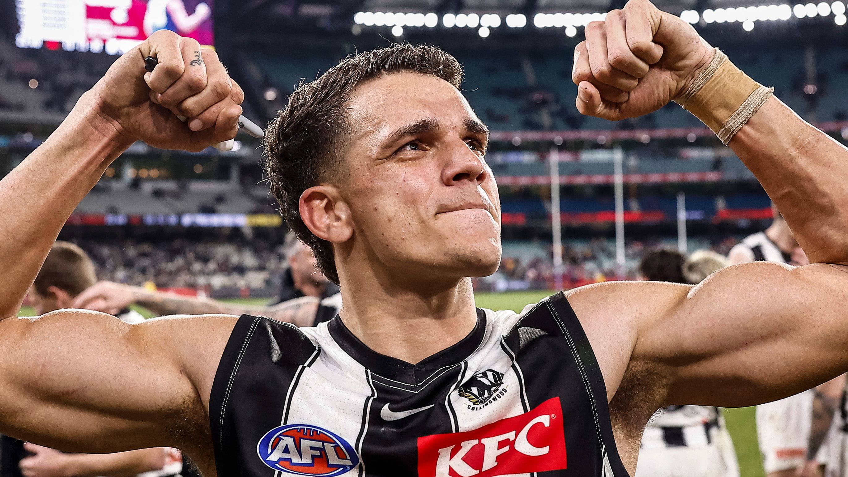 Ash Johnson of the Magpies acknowledges the fans after the round 21 AFL match between the Melbourne Demons and the Collingwood Magpies at Melbourne Cricket Ground on August 05, 2022 in Melbourne, Australia. (Photo by Darrian Traynor/Getty Images)