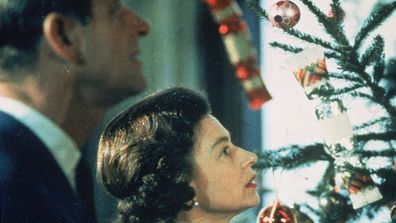 The Queen and Prince Philip looking at Christmas tree.