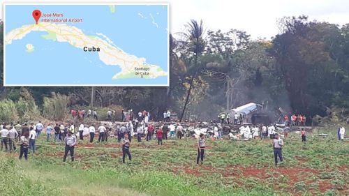 Rescue and search workers on the site where a Cuban airliner with 104 passengers on board plummeted into a yuca field just after takeoff. Picture: AP