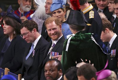 Prince Harry, centre, speaks with Anne, the Princess Royal in Westminster Abbey, ahead of the coronation of King Charles III and Camilla, the Queen Consort, in London, Saturday, May 6, 2023.