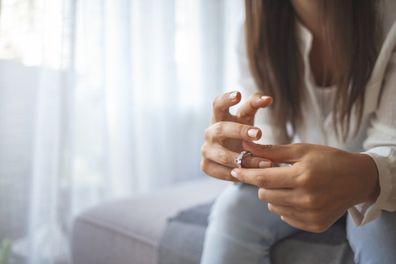 Unhappy woman holding wedding ring close up, upset girl crying, depressed with divorce, break up with boyfriend, broken engagement, feeling desperate, family split, bad relationships