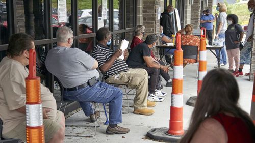 US job seekers exercise social distancing as they wait to be called into the Heartland Workforce Solutions office in Omaha, Neb. (July 2020)