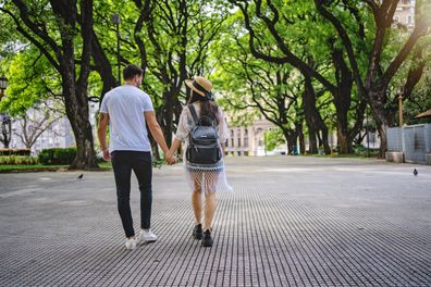 Boyfriend and girlfriend enjoying a date together in a public park stock image