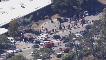 Police rush to the scene of a school shooting in Oakland, California.