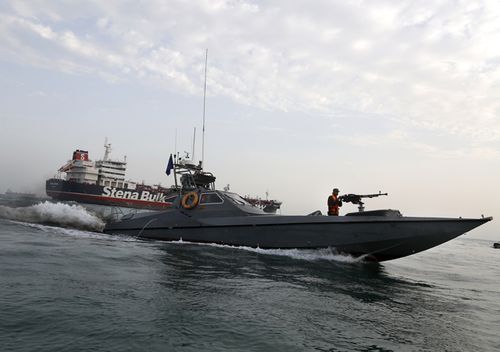 A speedboat of Iran's Revolutionary Guard moves around a British-flagged oil tanker Stena Impero, which was seized on Friday, in the Iranian port of Bandar Abbas. Iranian officials say the seizure of the British oil tanker was a justified response to Britain's role in impounding an Iranian supertanker two weeks earlier off the coast of Gibraltar, a British territory located on the southern tip of Spain.