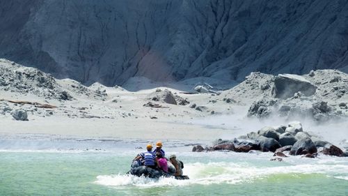 A photo provided by tourist Michael Schade shows rescuers leaving White Island following the eruption.