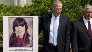 Suffolk County District Attorney Raymond Tierney, unseen, speaks at a news conference to announce the identity of a victim investigators had called the &quot;Jane Doe No. 7,&quot; as Karen Vergata, pictured at left, Friday, Aug. 4, 2023, in Hauppauge, New York. Law enforcement authorities said Friday they have identified a woman whose remains were found as far back as 1996 in different spots along the Long Island coast, some of them near the Gilgo Beach locations of bodies investigators believe were left 