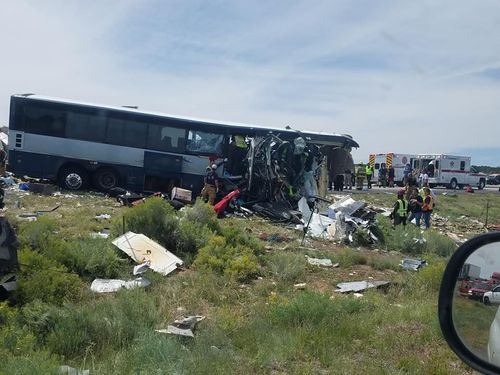 The truck was travelling eastbound around 12:30 p.m. when it blew a tire, lost control, crossed the median and struck the westbound bus 