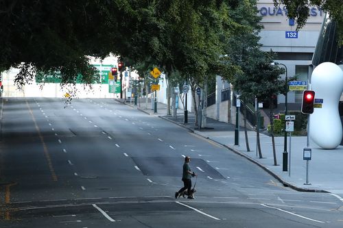 BRISBANE, AUSTRALIA - JULY 31: People are seen walking near the Brisbane CBD after lockdown on July 31, 2021 in Brisbane, Australia. Eleven local government areas in south-east Queensland will enter into a three-day lockdown from 4pm today as six new locally transmitted cases of the Covid-19 delta variant were reported.  (Photo by Jono Searle/Getty Images)