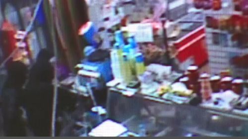 The thieves (left) could be seen at the cash register of the Werribee store. (Victoria Police)