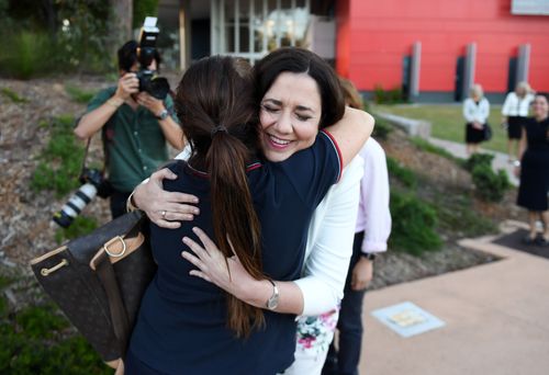 Annastacia Palaszczuk hugs a a nursing staff member outside the Gold Coast University Hospital. (AAP)