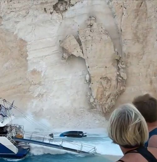 A rock wall has peeled off the cliff face surrounding the popular Greek beach of Navagio injuring tourists.