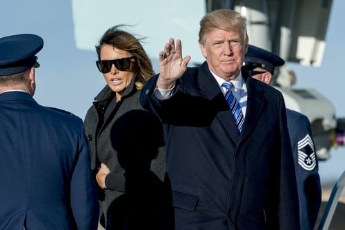 President Donald Trump, accompanied by first lady Melania Trump, waves to members of the media as they arrive at Andrews Air Force Base, Md., Saturday, March 3, 2018 to board Marine One for a short trip to the White House. (AP Photo/Andrew Harnik)