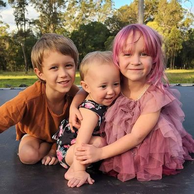 Ollie with his two sisters before his diagnosis.