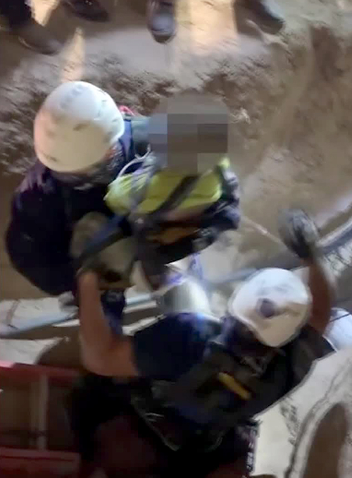 A frame from a video released by the City of Mission, Texas, shows a boy being rescued from a well. The boy's face was obscured at the time of release.