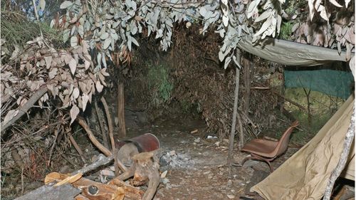 The "hide" made of leaves, branches and logs that was used by Nathaniel Train as a concealed shooting position during the fatal ambush of two Queensland police officers at Wieambilla.