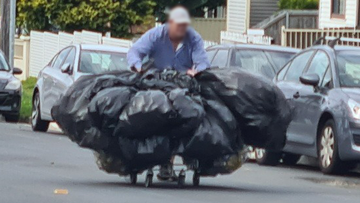 A man was photographed on Sydney&#x27;s Northern Beaches carrying a titanic load of recycling.