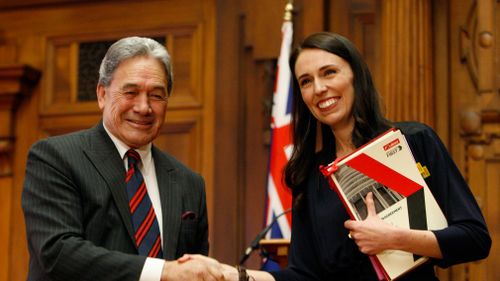 Zealand First leader Winston Peters, left, and Prime Minister-designate Jacinda Ardern shake hands after signing a coalition agreement October 24. (AAP)