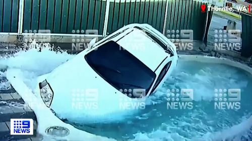 CCTV has captured the moment a young woman ploughed her car through the fence of a Perth home and landed in the swimming pool. 