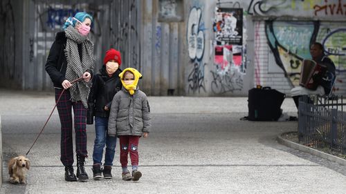 A woman with her children walk their dog in Prague, Czech Republic, amid the coronavirus pandemic. 