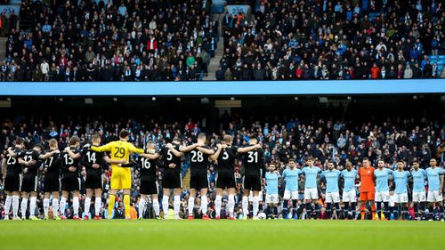 Manchester City and Burnley players stand for a minutes silence in memory of Emiliano Sala during the Emirates FA Cup Fourth Round match at the Etihad Stadium