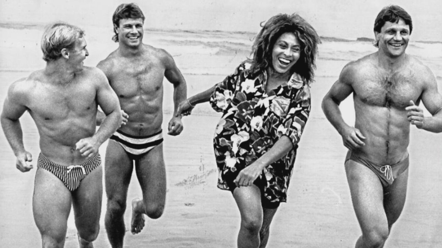 The iconic shot of Tina Turner running on the beach with rugby league superstars Allan Langer (left), Andrew Ettinghausen and Wayne Pearce.