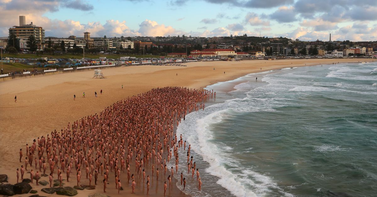 Thousands strip off at Bondi Beach for renowned photographer