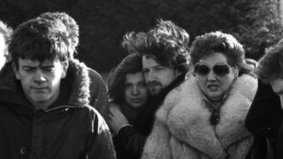 To left, U2 manager Paul McGuinness. Beside lady in fur coat are husband and wife Ali Hewson and Bono. 11/01/1986 (Part of the Independent Newspapers Ireland/NLI Collection). (Photo by Independent News And Media/Getty Images)