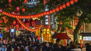 People tour the popular Shibati shopping street decorated with red lanterns 