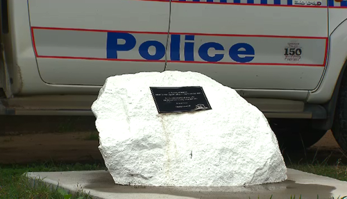 A large white rock outside the police station still sits as a memorial to Mulrunk Doomagee - a reminder that the people of Palm Island will not forget. (9NEWS)