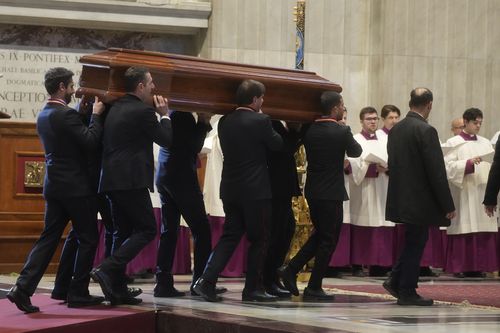 The coffin of Australian Cardinal George Pell is carried in St. Peter's Basilica before the funeral ceremony at the Vatican, Saturday Jan. 14, 2023. 