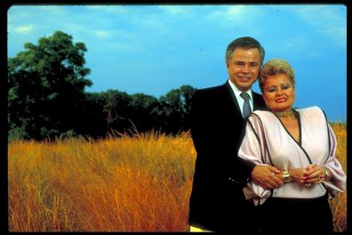 Former televangelists Jim and Tammy Faye Bakker standing in the middle of a wheat field.  (Photo by Will And Deni McIntyre/Getty Images)