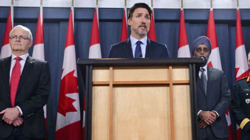 Prime Minister Justin Trudeau holds a press conference in Ottawa on Wednesday, Jan. 8, 2020, flanked by Transport Minister Marc Garneau (left), Defence Minister Harjit Sajjan and Gen. Jonathan Vance.